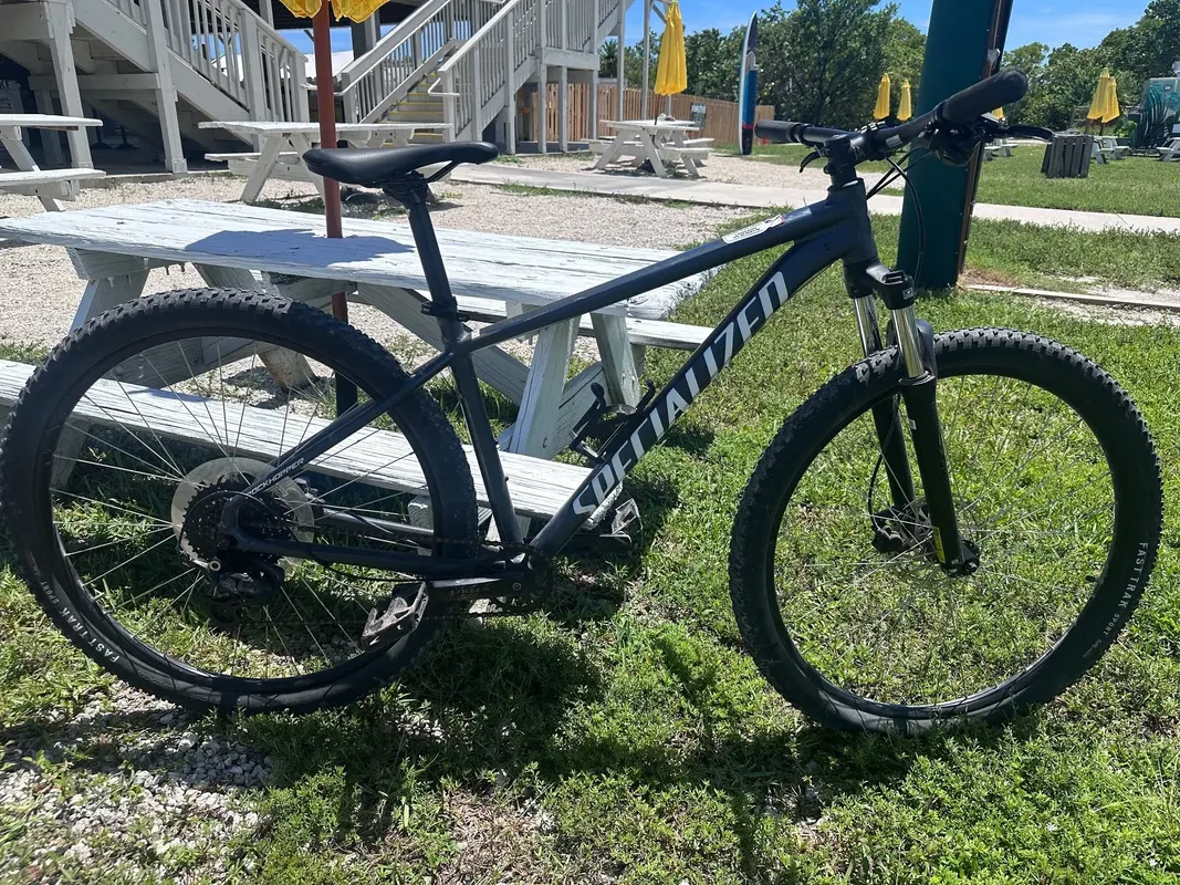 A mountain bike parked on the grass at the Oleta River outdoor center