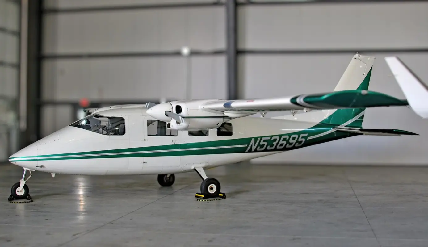 A multi-engine airplane parked in a hangar