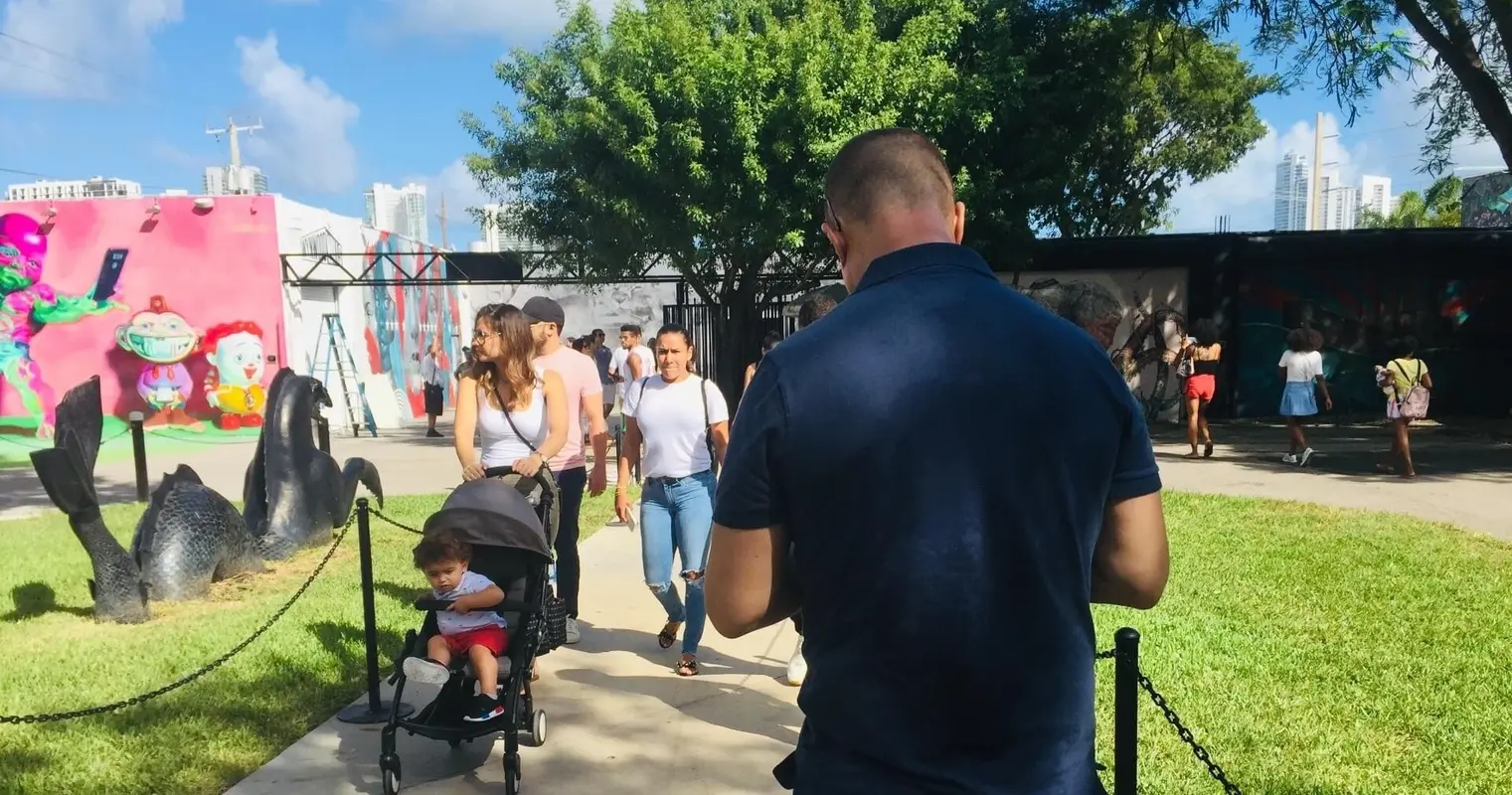 Visitors walking past murals and sculptures in Wynwood Walls