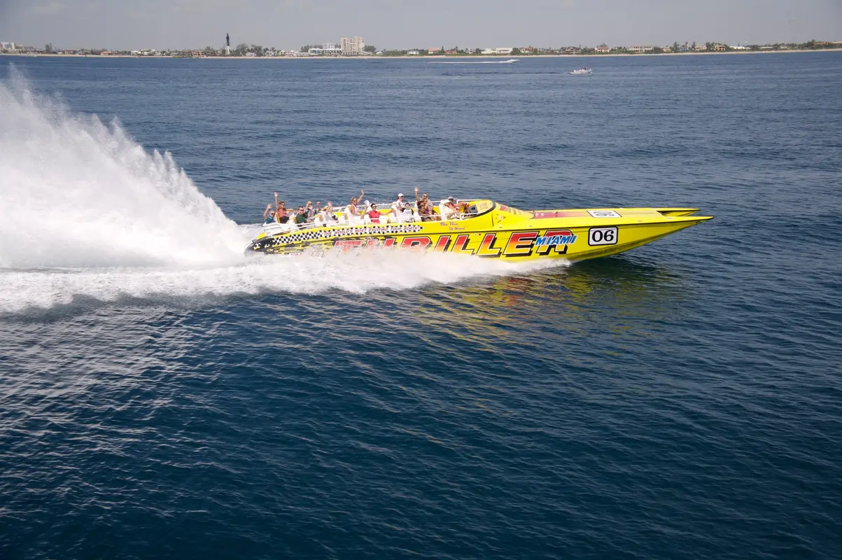 A yellow Thriller speedboat throwing spray across open water