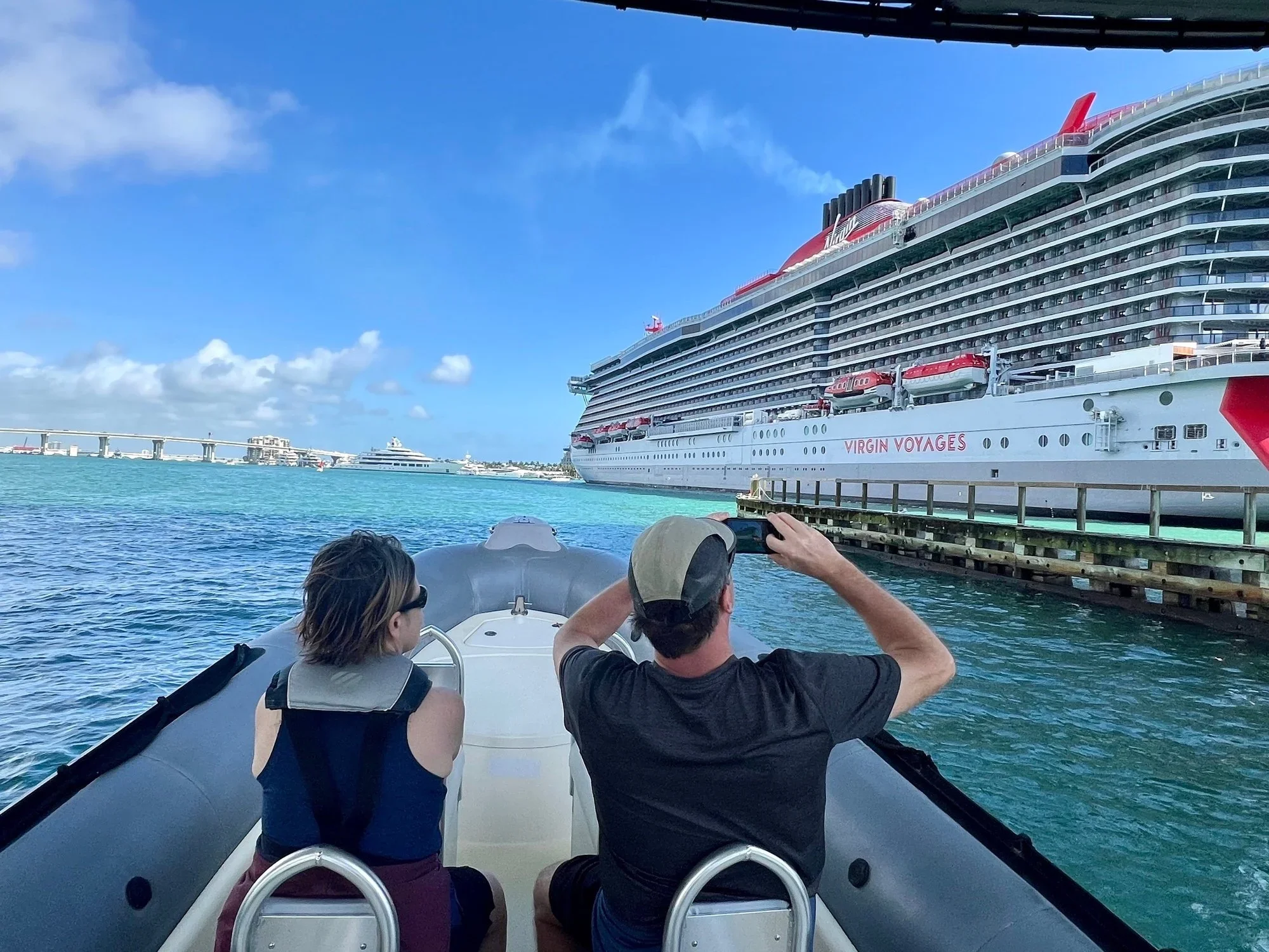 Passengers photographing a cruise ship docked at Port Miami
