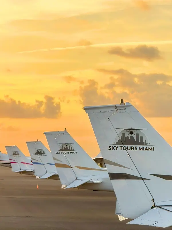 Tails of Sky Tours Miami airplanes lined up at sunset
