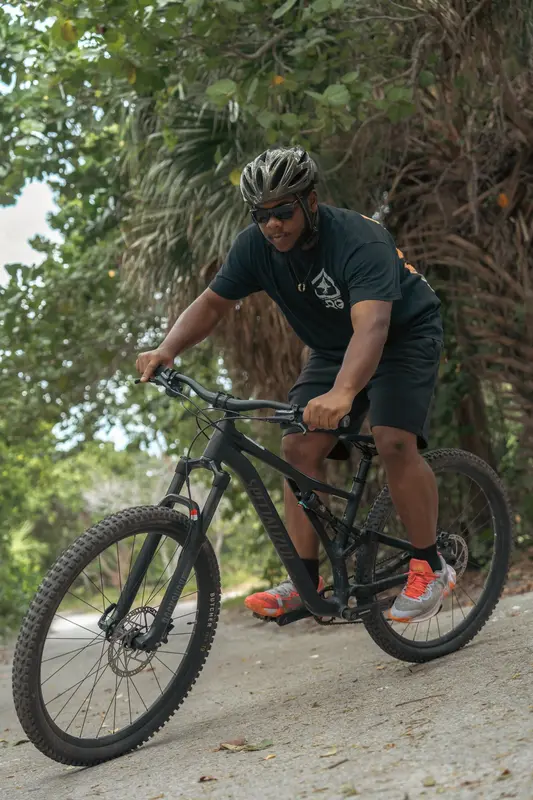 A rider in a helmet on a mountain bike trail