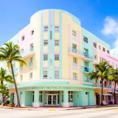 A pastel Art Deco corner building framed by palm trees