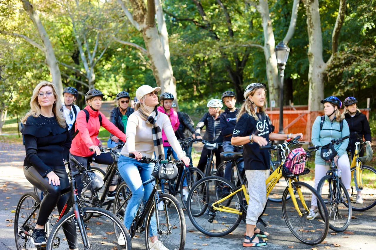 Cyclists gathered beside a shaded park path