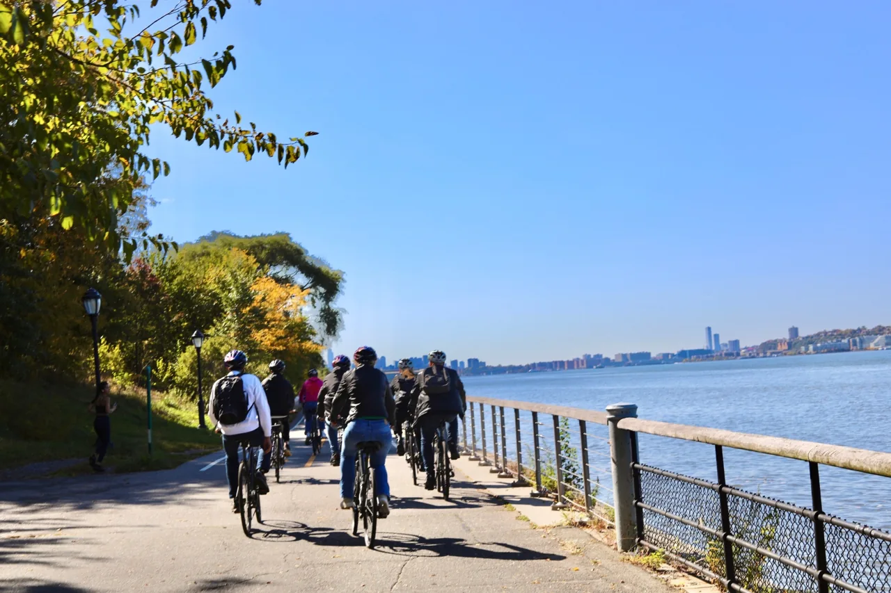 Cyclists on a waterfront path overlooking the bay