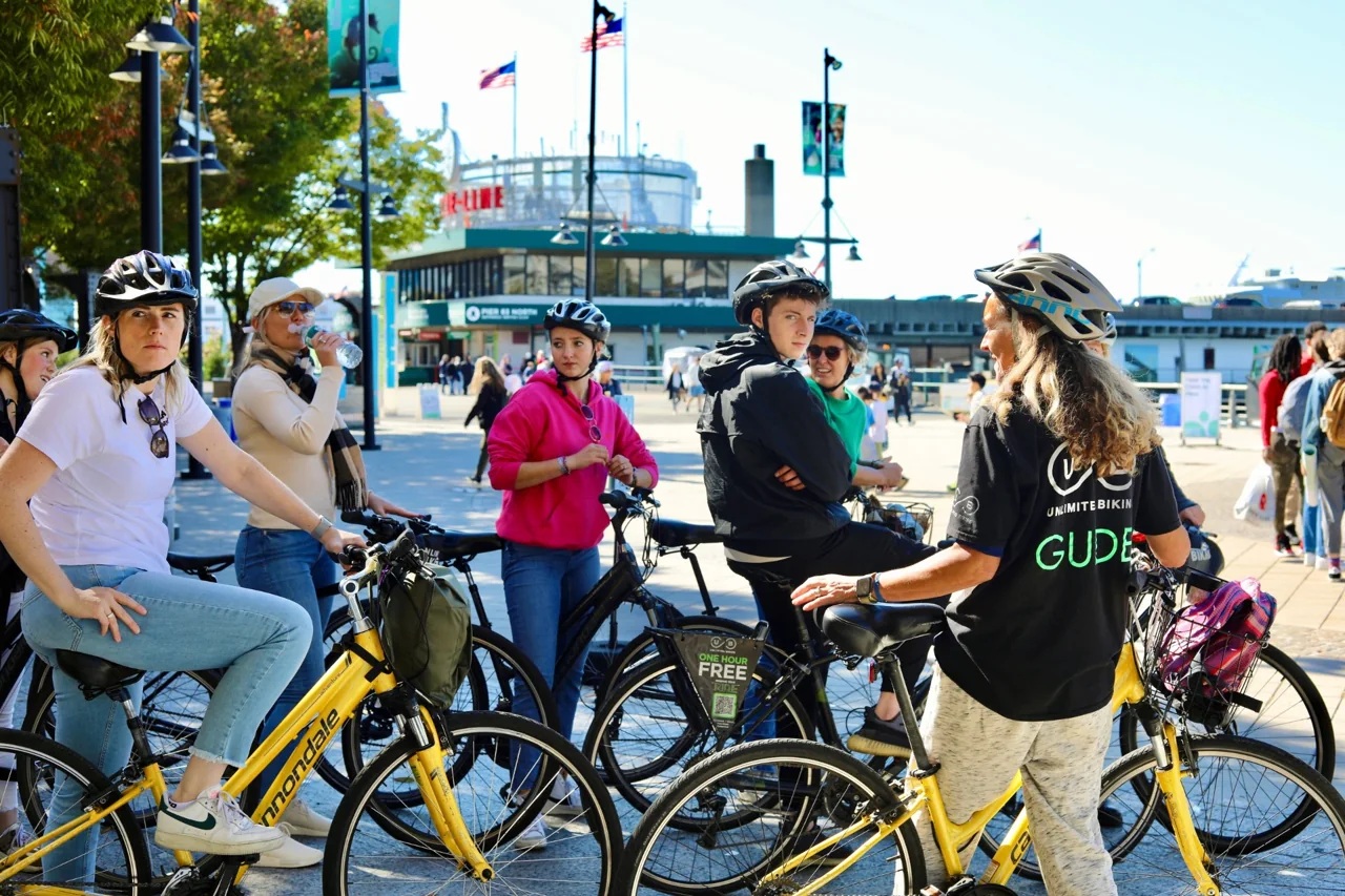 A bicycle tour group gathered near a waterfront park