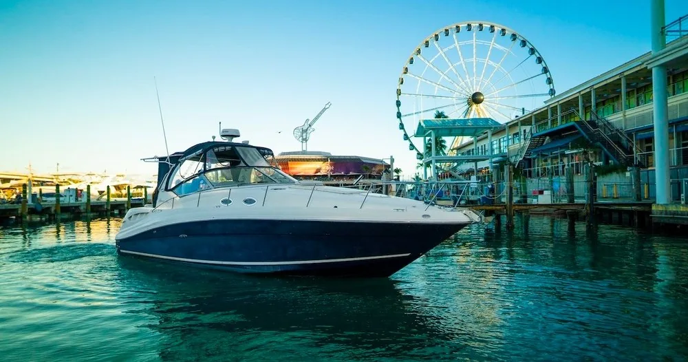 A motorboat beside the waterfront observation wheel
