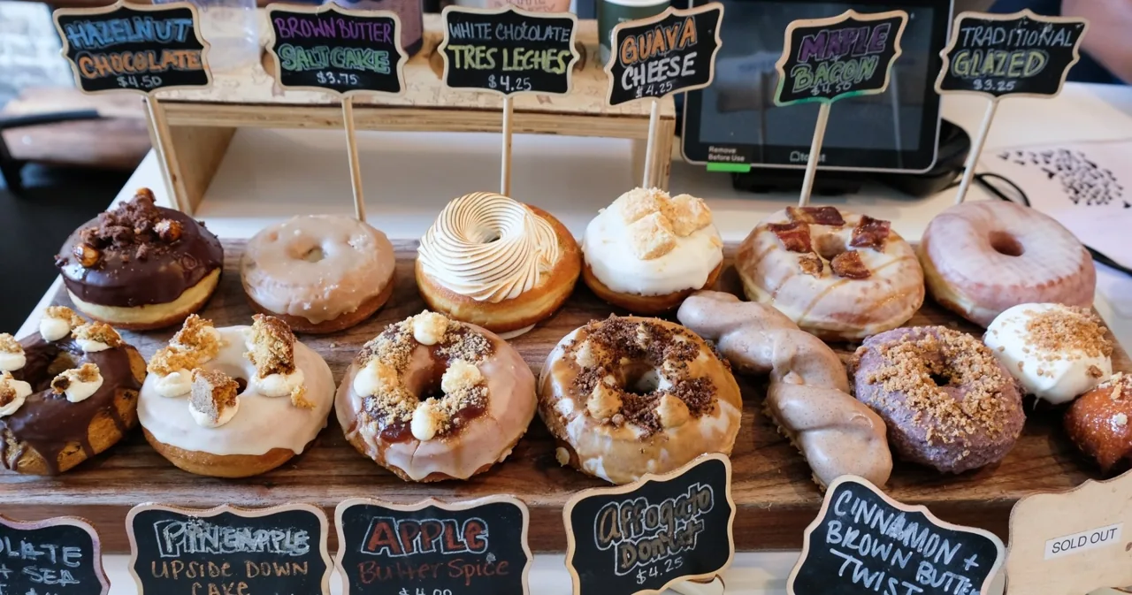 Donuts arranged beside small bakery signs