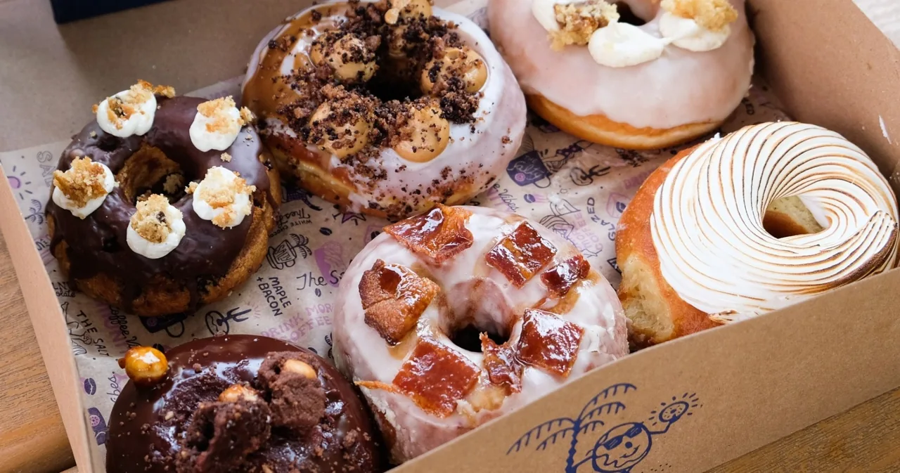 Chocolate and glazed donuts in a display case
