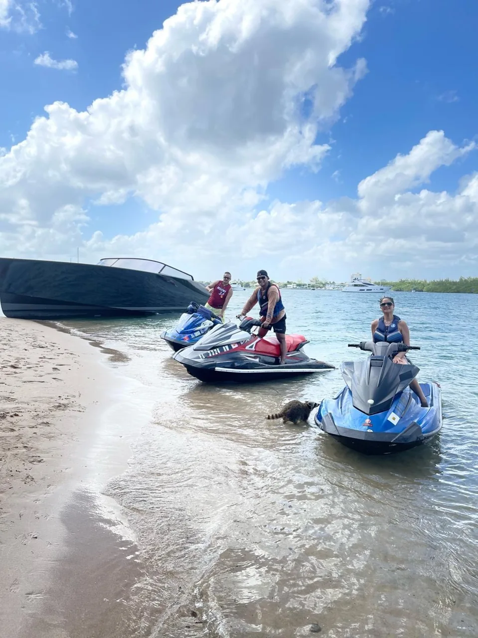 Jet ski riders crossing the bay beneath cloudy skies
