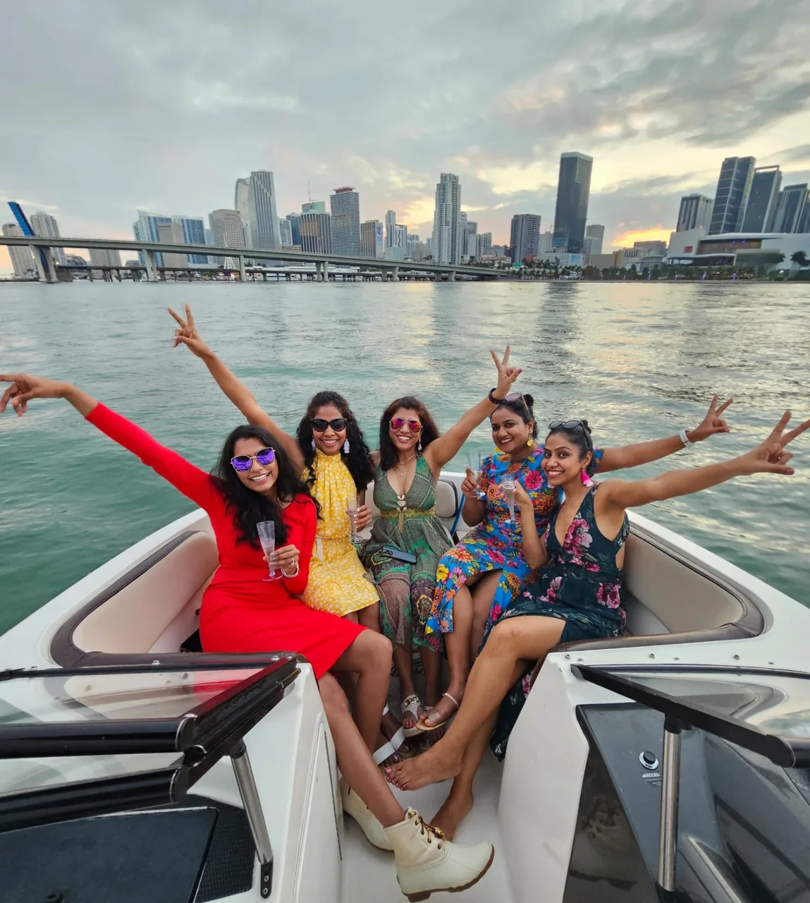 Passengers seated on a motorboat with the Miami skyline behind them