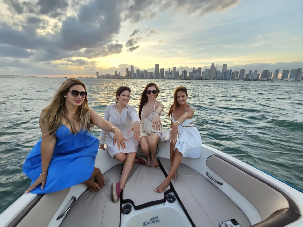 A group seated in a boat beneath cloudy skies