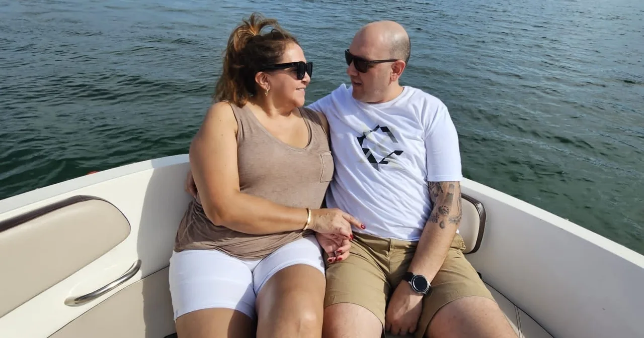 Two passengers relaxing in the bow of a motorboat