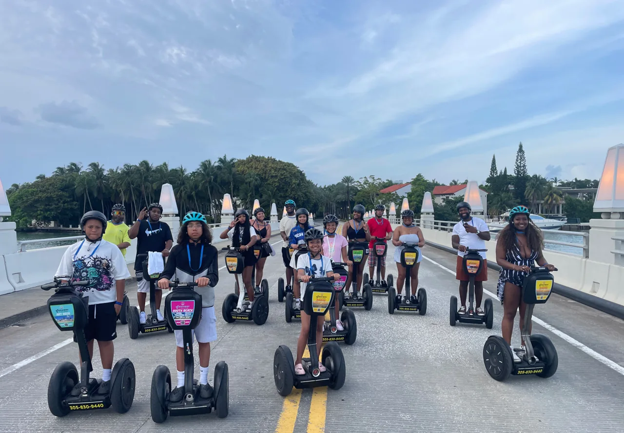 A Segway tour group gathered beside a park