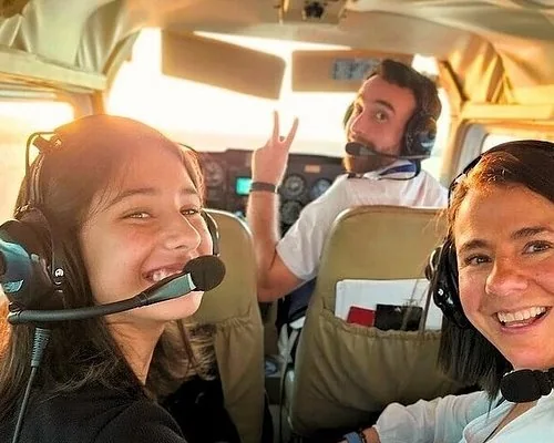 Passengers wearing headsets inside a small airplane