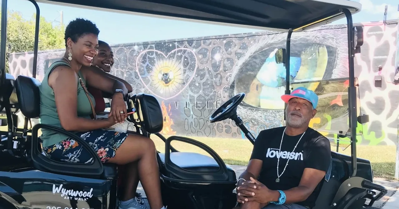 Passengers seated inside a golf cart