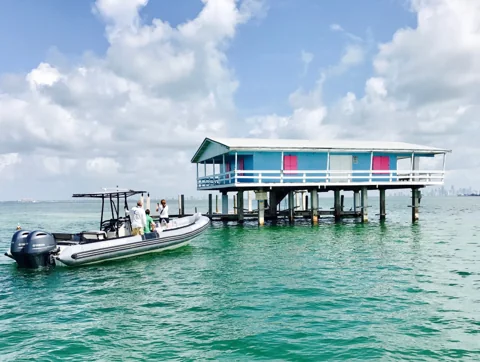 Boat beside the stilt houses of Stiltsville in Biscayne Bay