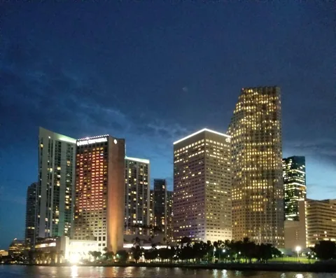 Miami high-rises illuminated against a dark sky