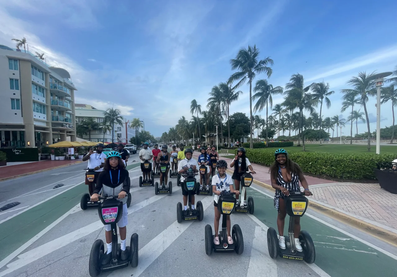 Segway riders on a palm-lined South Beach path