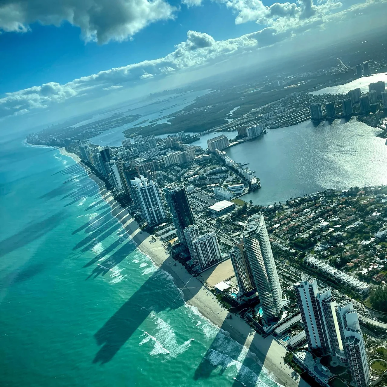 Aerial view of the Miami coastline, high-rises and turquoise ocean